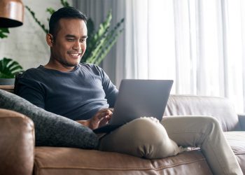 man at home using his laptop