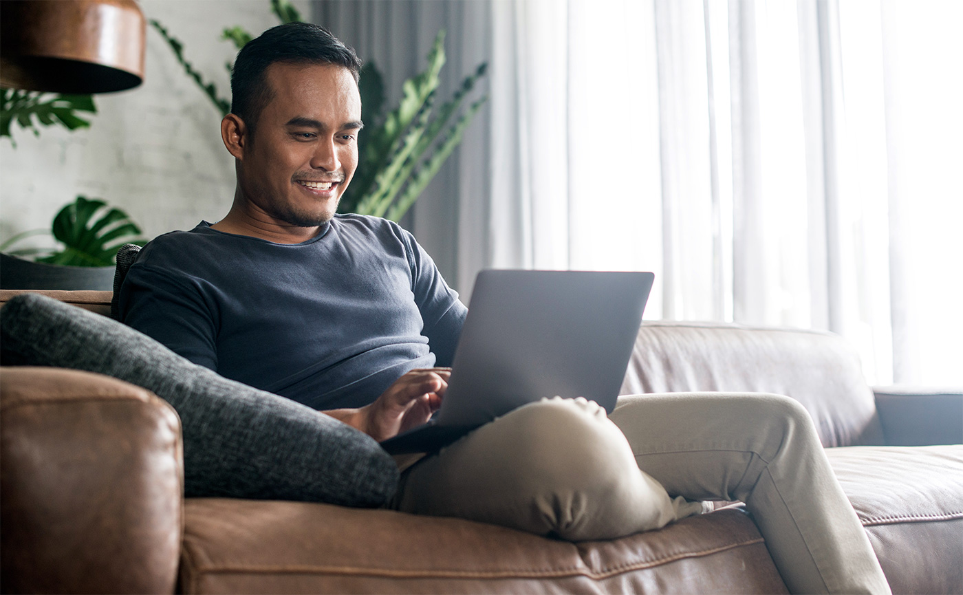 man at home using his laptop